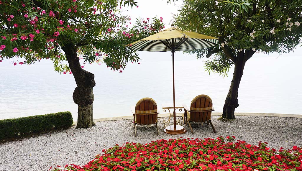 Lounges in the garden of Villa Feltrinelli Lake Garda Italy