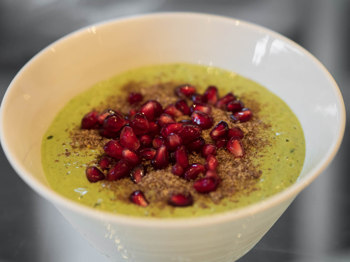 Lactose free yogurt with spinach, pumpkin seeds protein powder, flax seeds and pomegranate seeds