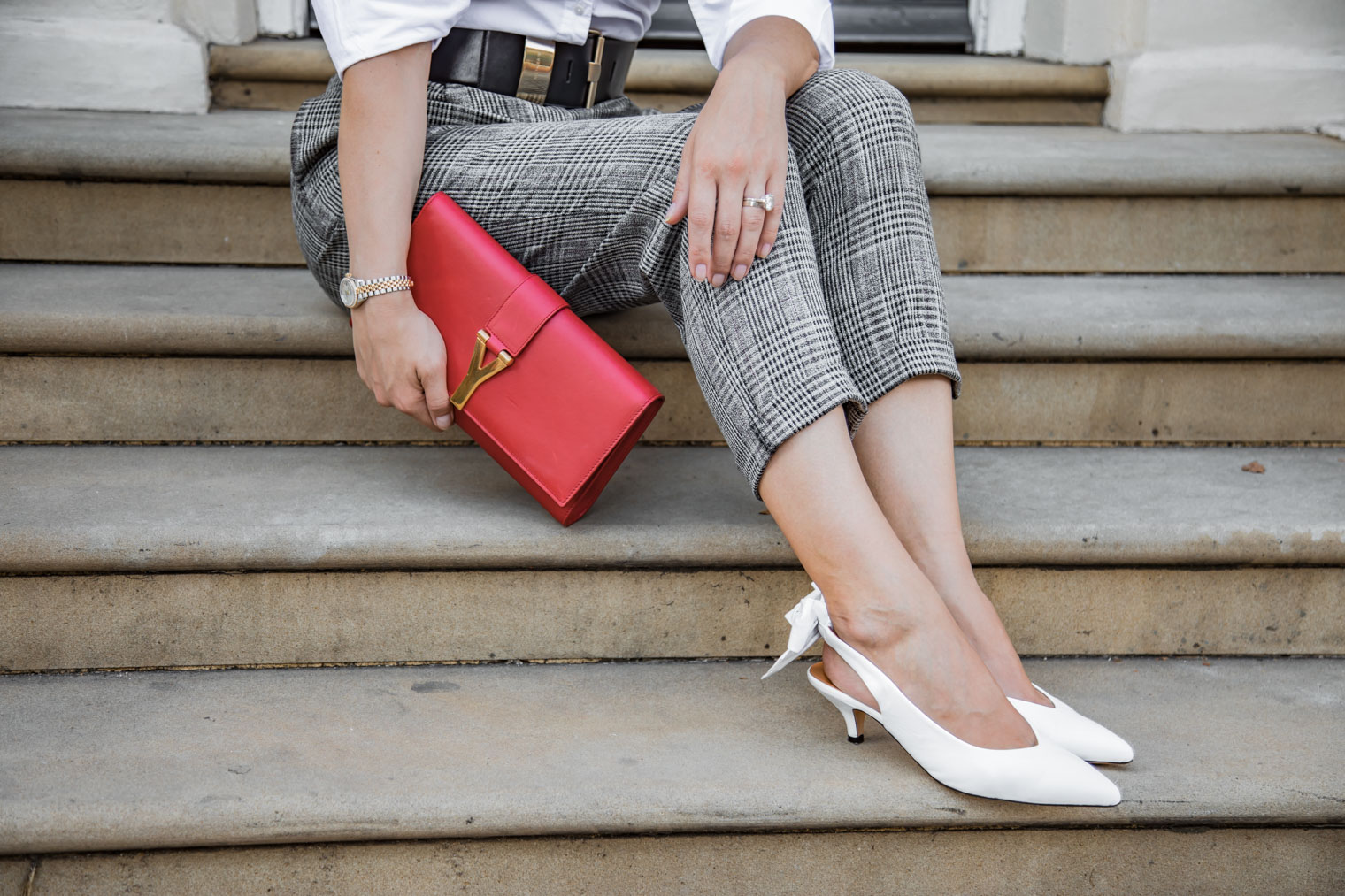 White slingbacks and Saint Laurent red clutch