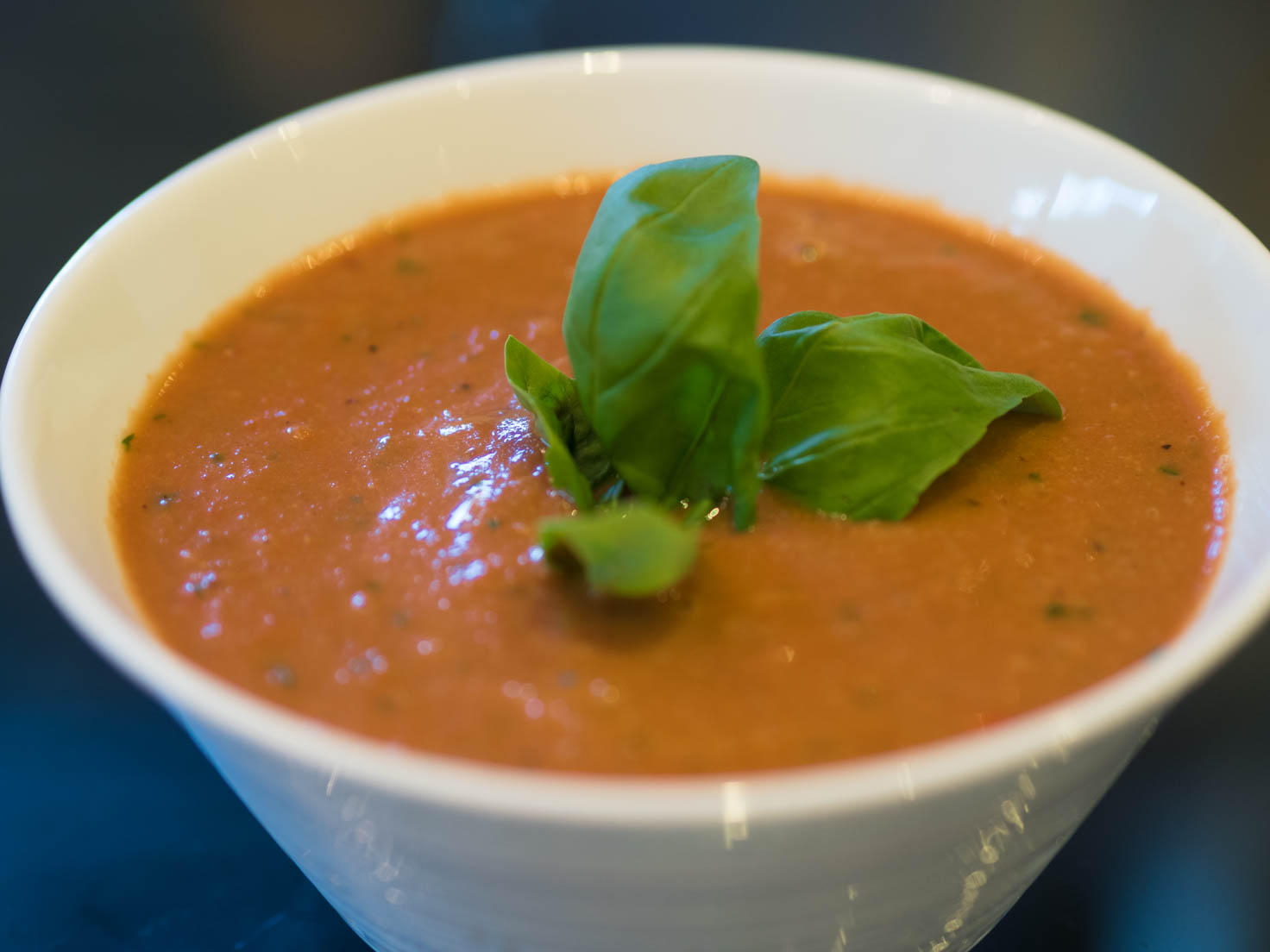 Roasted tomatoes soup with balsamic vinaigrette and basil